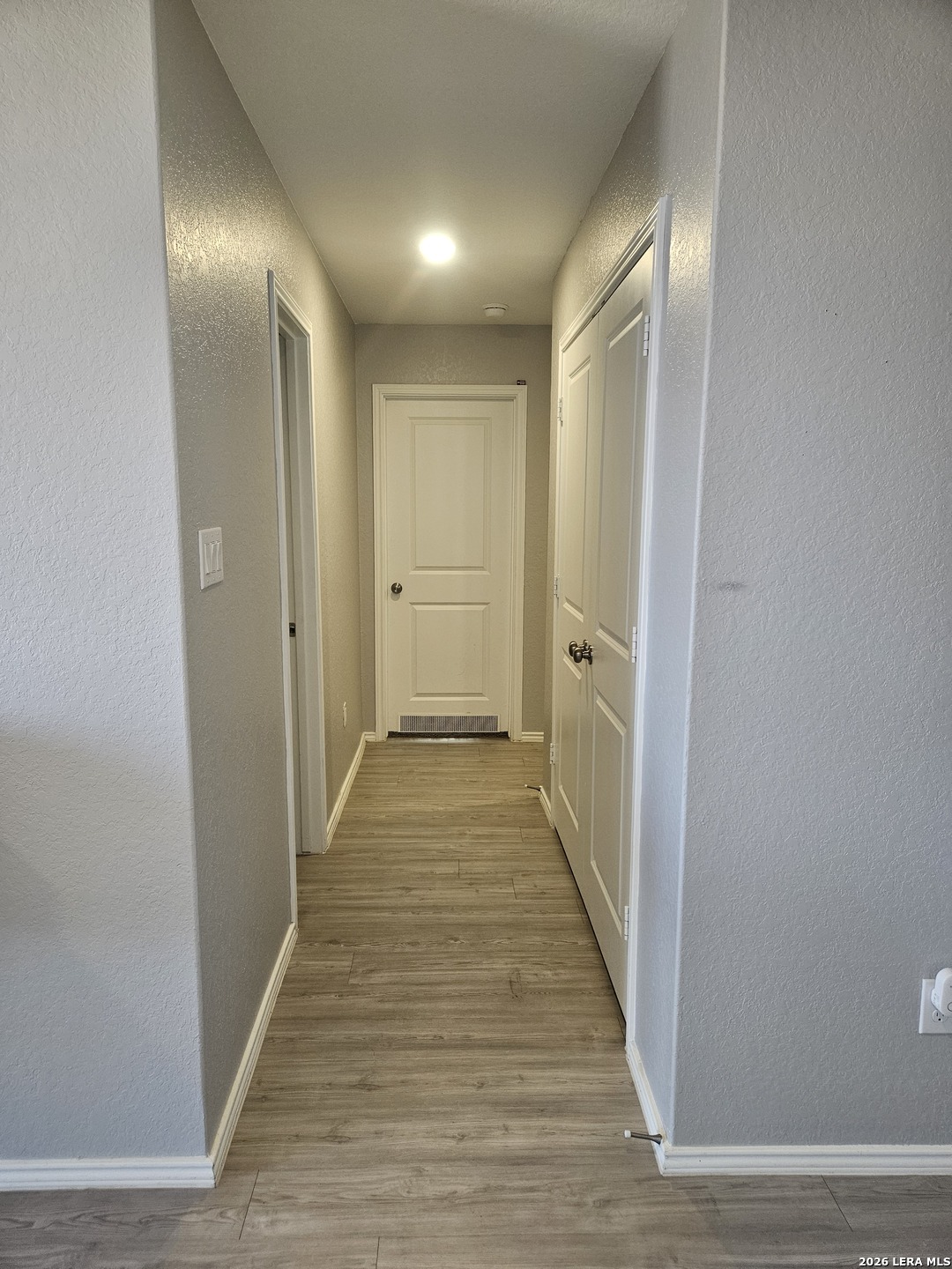 6855 Burgess Ridge Converse, TX 78109 - Photo 11 of 24 a view of a hallway with wooden floor