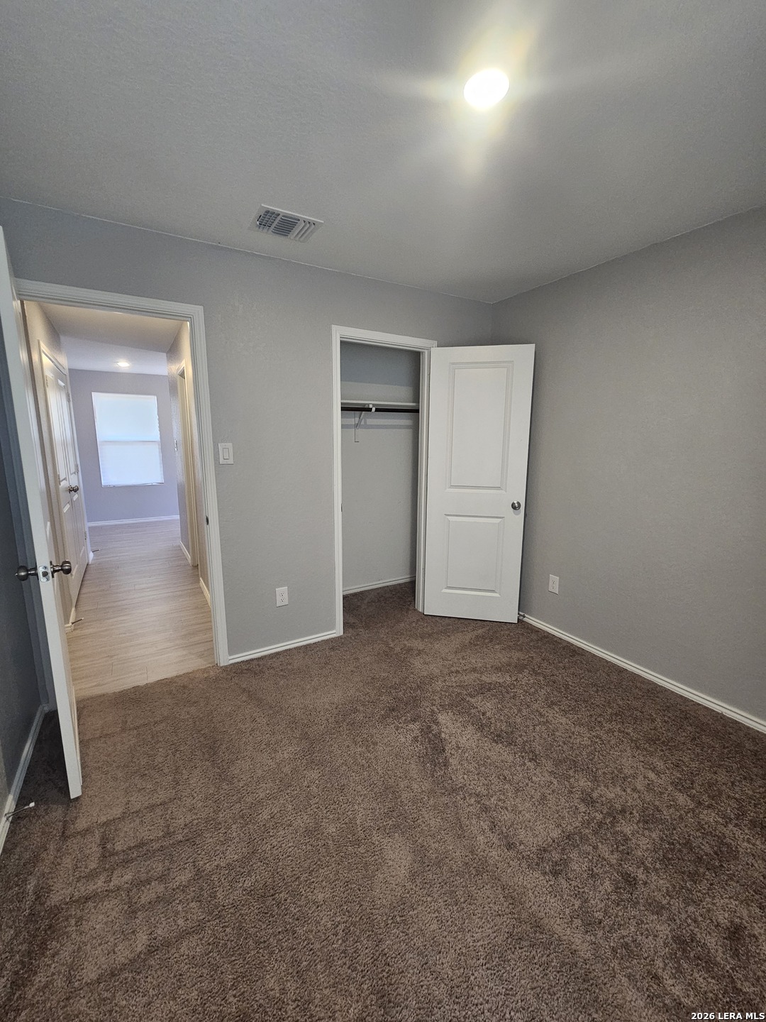 6855 Burgess Ridge Converse, TX 78109 - Photo 15 of 24 an empty room with closet and mirror