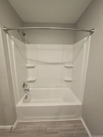 a bathroom with a shower and a bath tub