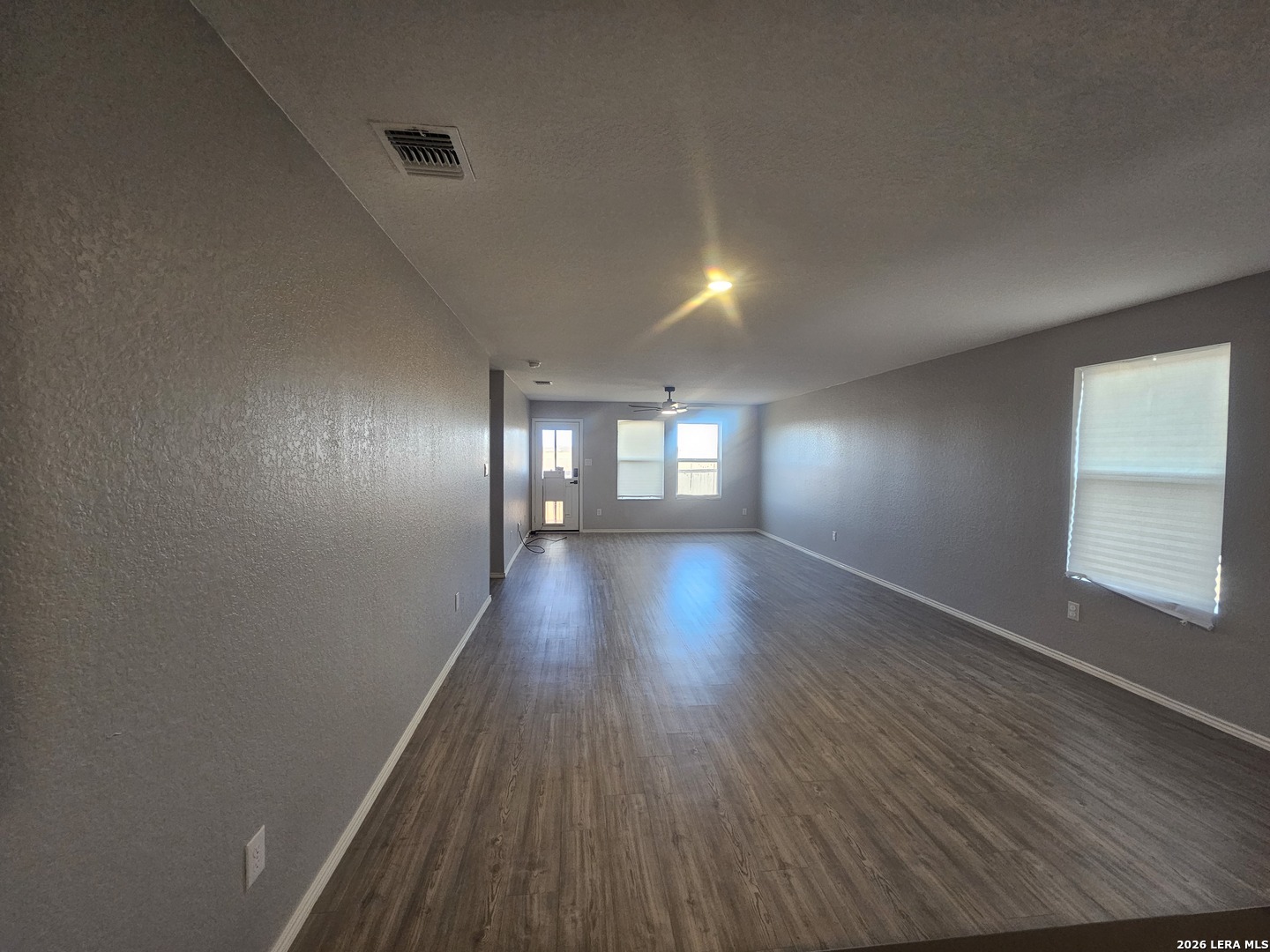 6855 Burgess Ridge Converse, TX 78109 - Photo 5 of 24 wooden floor in an empty room with a window