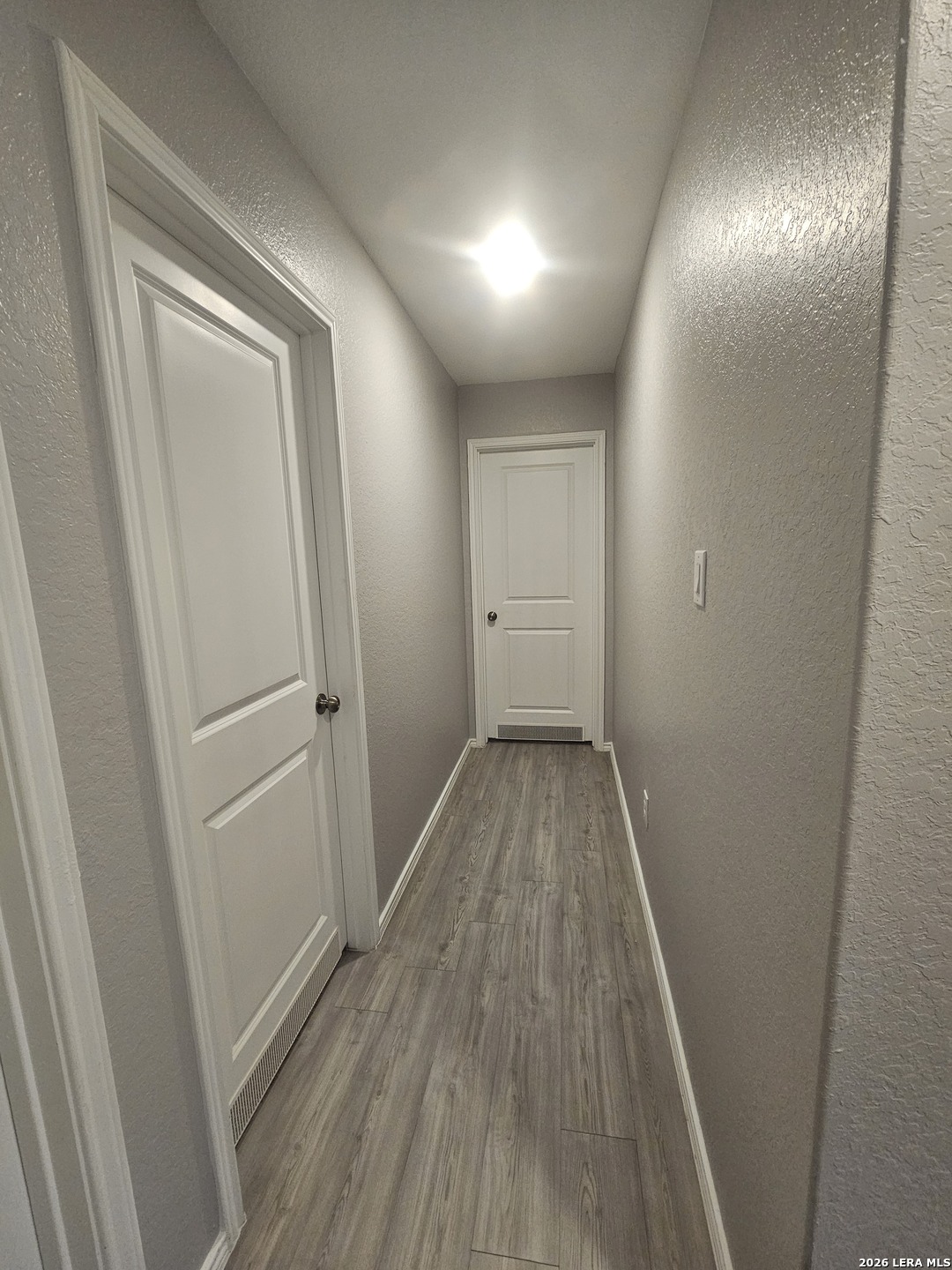 6855 Burgess Ridge Converse, TX 78109 - Photo 10 of 24 a view of a hallway with wooden floor