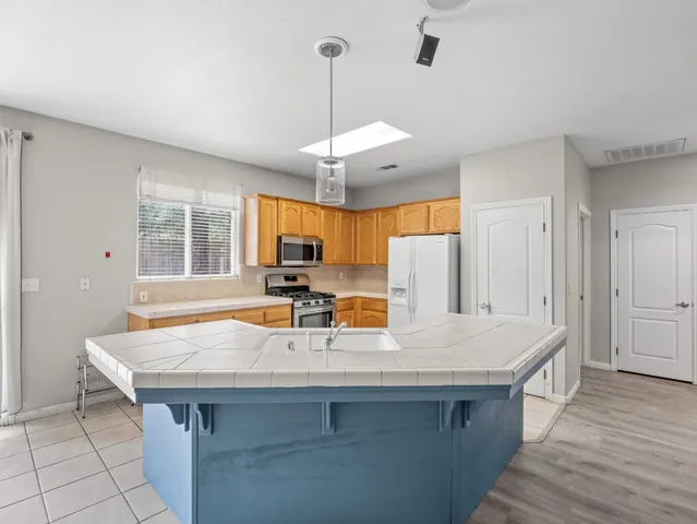 a kitchen with a counter space cabinets and wooden floor
