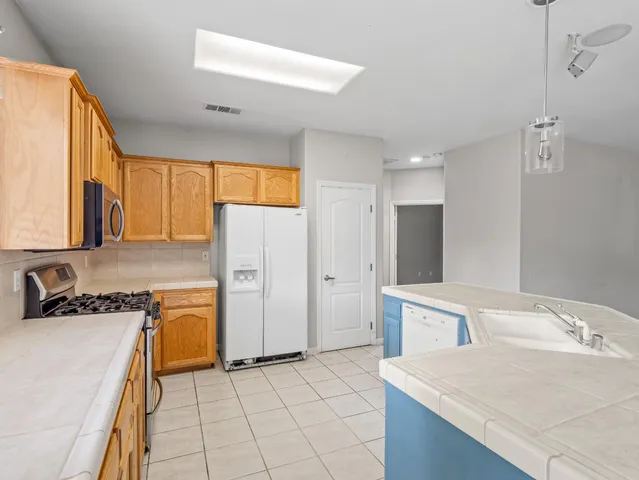 a kitchen with a sink appliances and cabinets