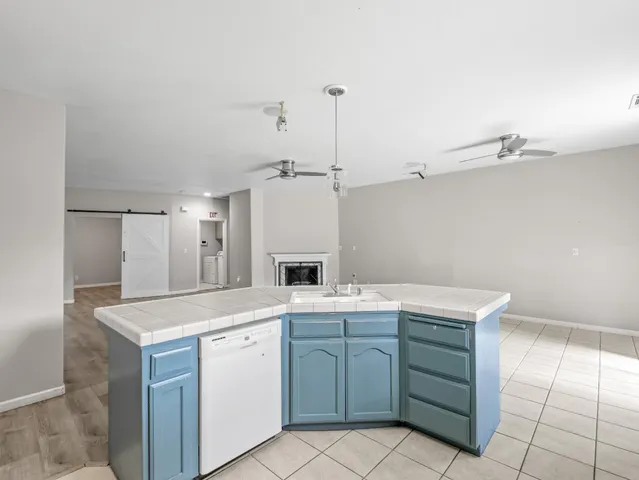 a utility room with cabinets washer and dryer