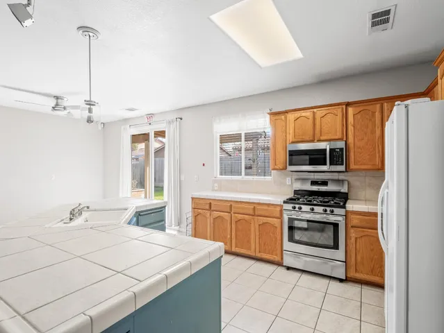 a kitchen with stainless steel appliances a stove sink and refrigerator