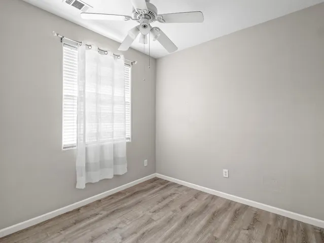 an empty room with wooden floor