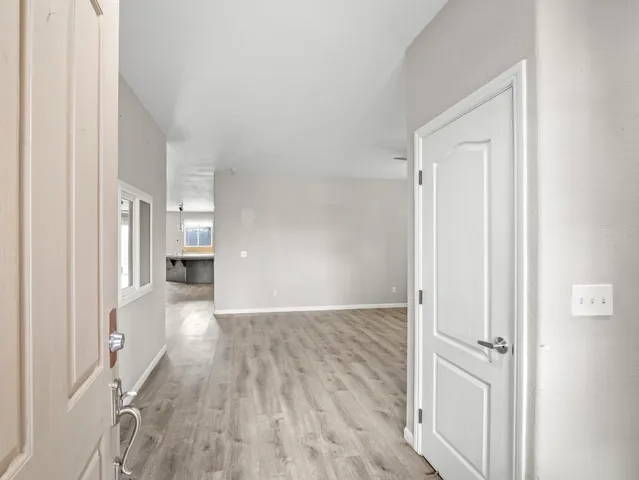 a view of a hallway with wooden floor