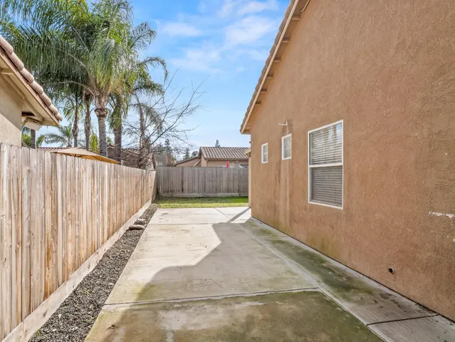 a backyard of a house with yard and outdoor seating