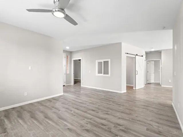 a view of an empty room with wooden floor
