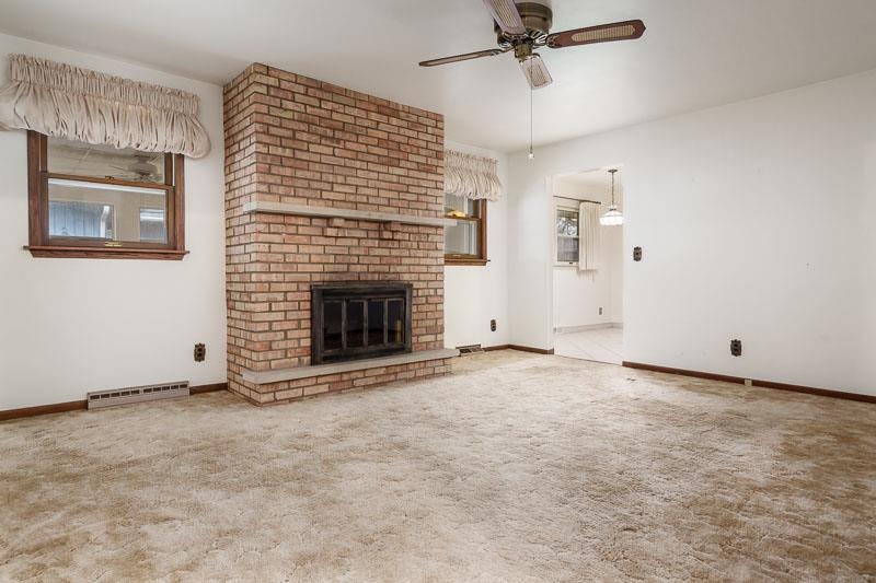 1110 Roxbury Close Rockford, IL 61107 - Photo 6 of 36 an empty room with fireplace and fan