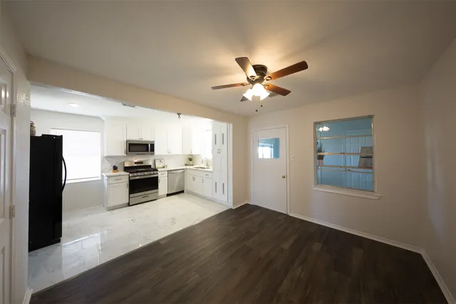 a view of a kitchen with microwave and stove top oven