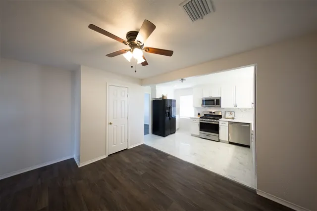 a kitchen with stainless steel appliances a refrigerator and a stove top oven