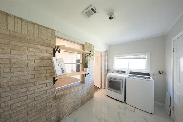 a bathroom with a granite countertop sink a large mirror and a bathtub