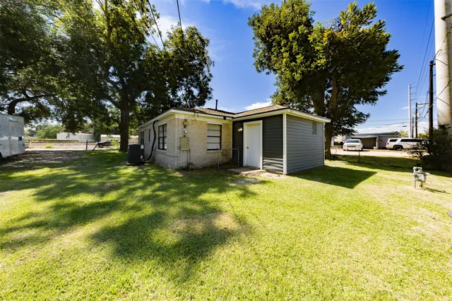 a view of a backyard with large trees