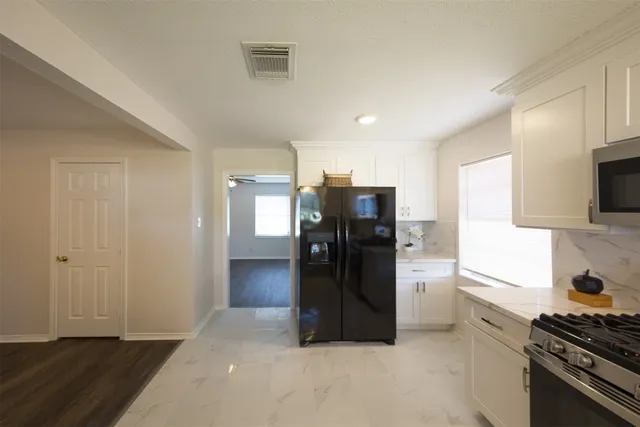 a kitchen with a refrigerator and a stove