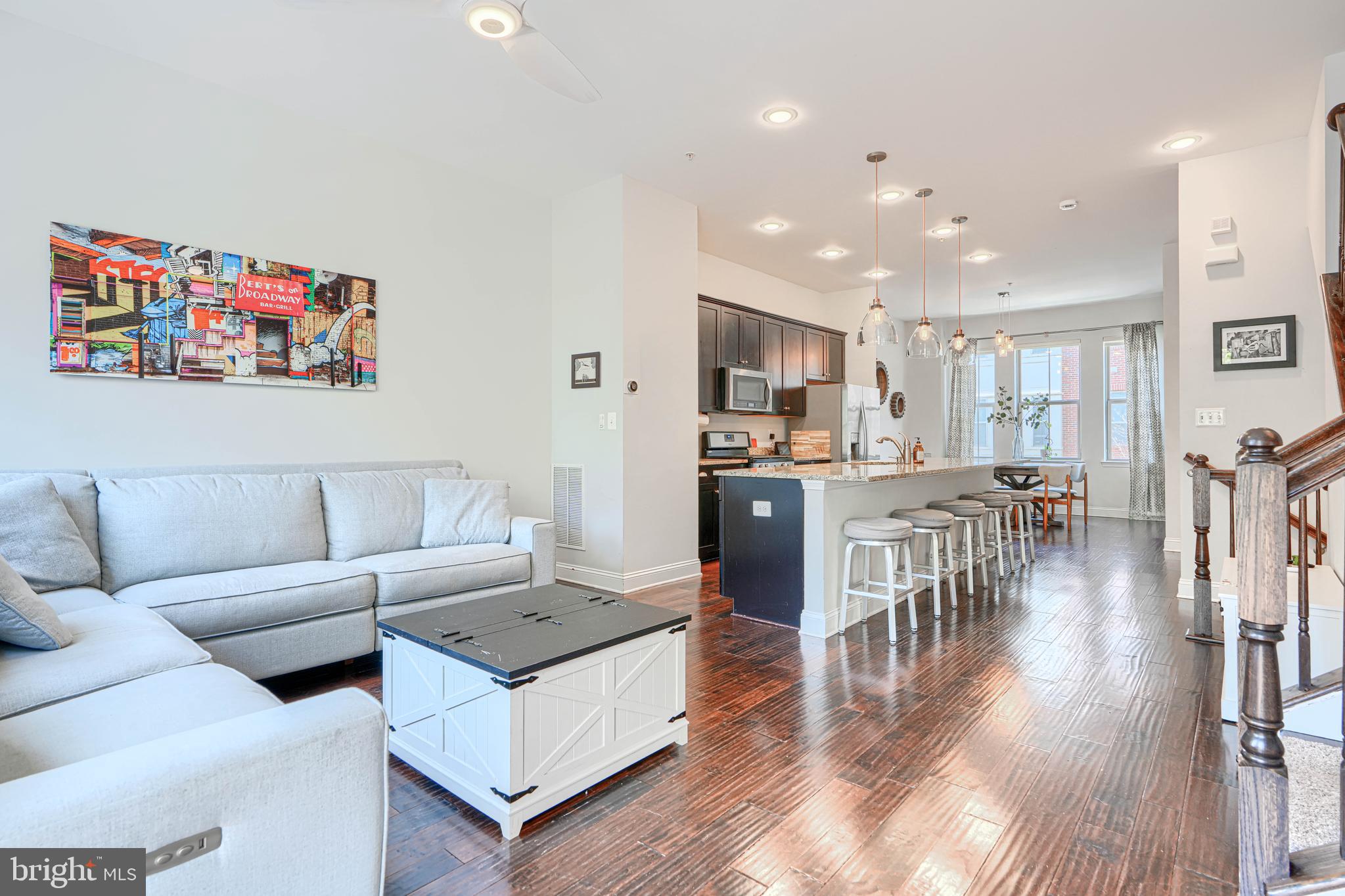 1309 Benjamin Street Baltimore, MD 21230 - Photo 14 of 60 a living room with furniture and kitchen view with wooden floor