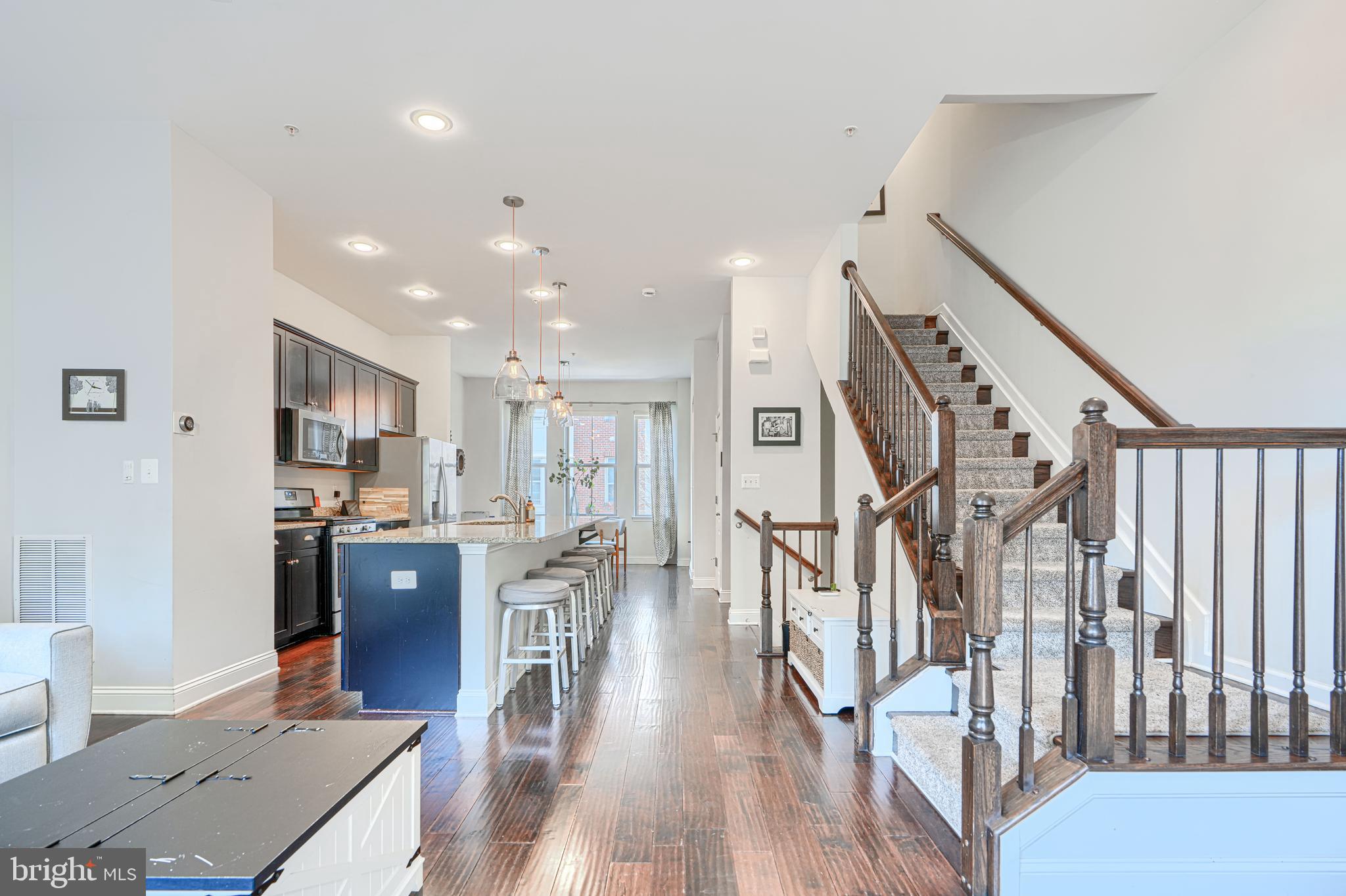 1309 Benjamin Street Baltimore, MD 21230 - Photo 15 of 60 a living room with stainless steel appliances kitchen island granite countertop furniture wooden floor and a dining table