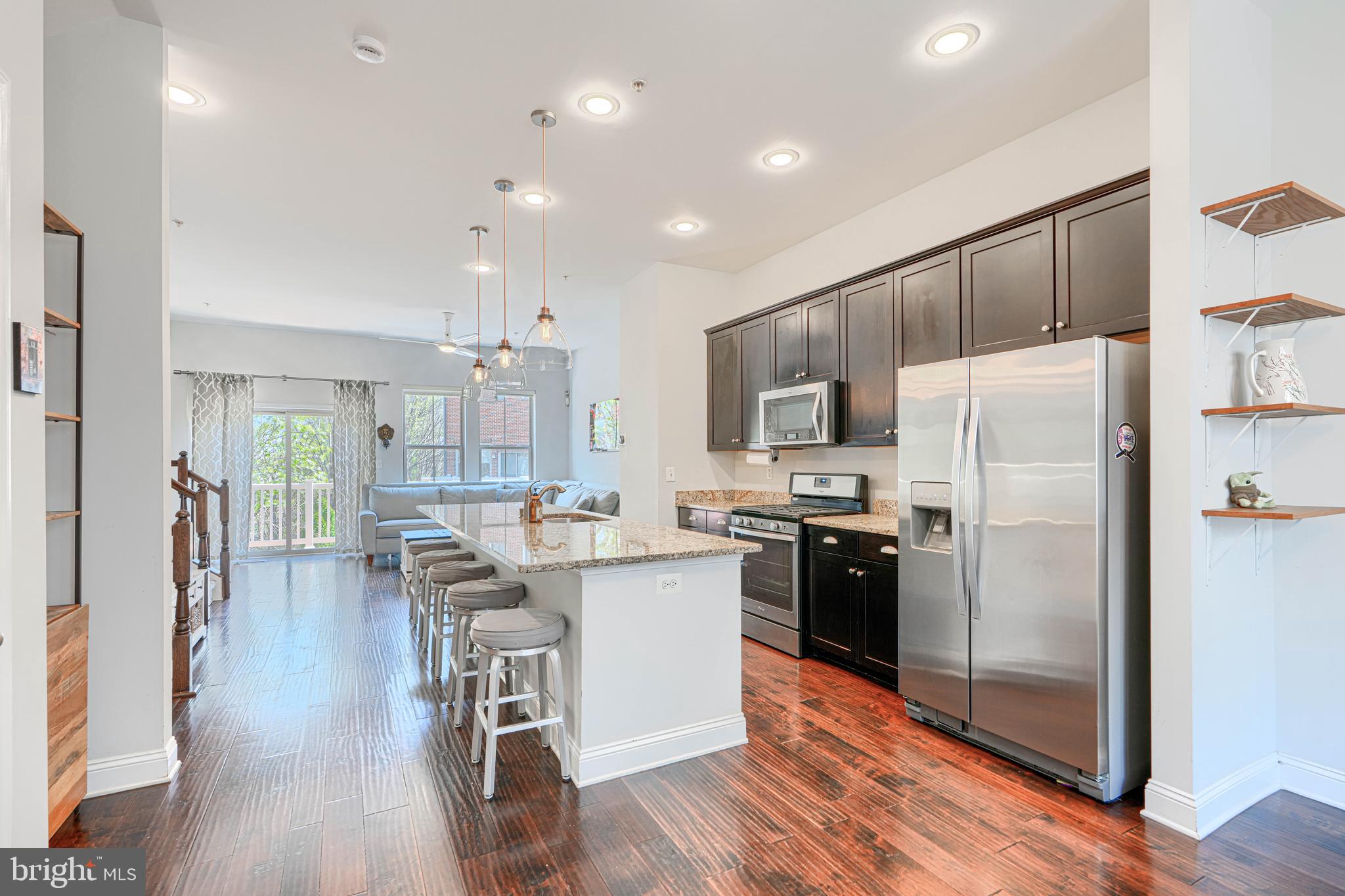 1309 Benjamin Street Baltimore, MD 21230 - Photo 23 of 60 a kitchen with kitchen island white cabinets and stainless steel appliances