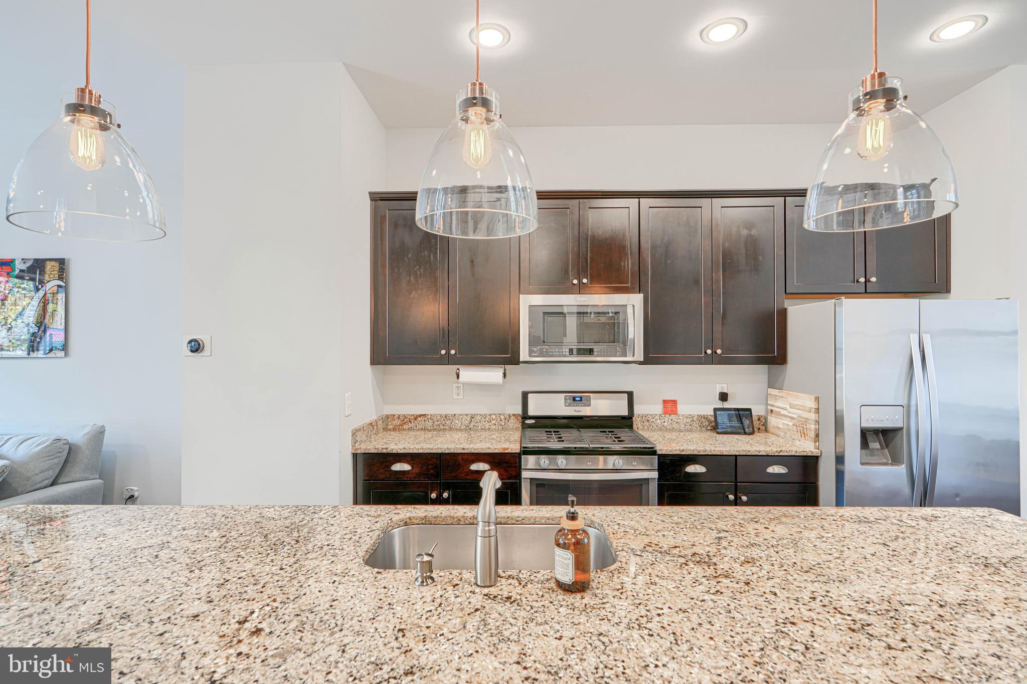 1309 Benjamin Street Baltimore, MD 21230 - Photo 25 of 60 a kitchen with stainless steel appliances kitchen island granite countertop a refrigerator and a stove top oven