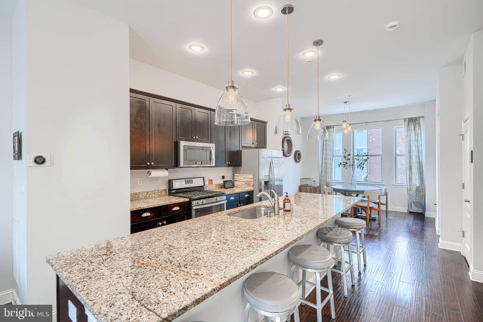 1309 Benjamin Street Baltimore, MD 21230 - Photo 26 of 60 a kitchen with stainless steel appliances kitchen island granite countertop a sink refrigerator and cabinets