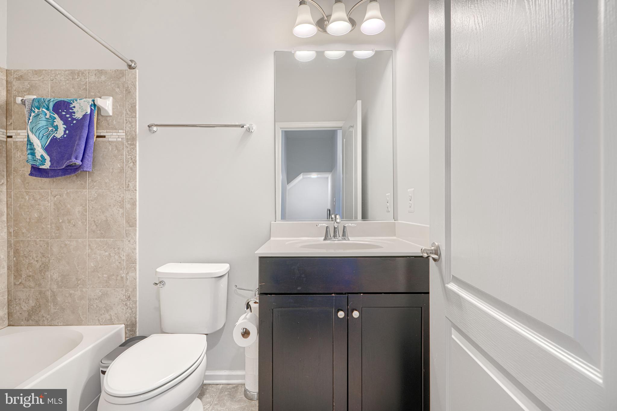 1309 Benjamin Street Baltimore, MD 21230 - Photo 41 of 60 a bathroom with a toilet a sink and mirror