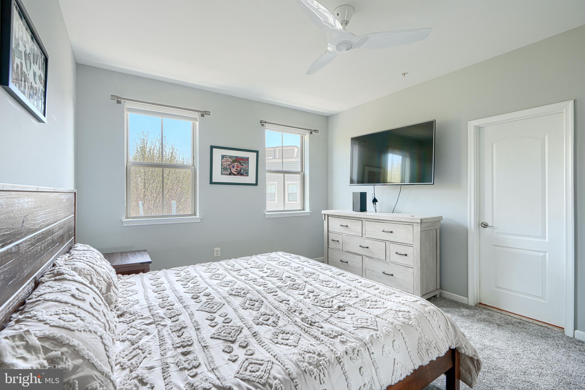 1309 Benjamin Street Baltimore, MD 21230 - Photo 45 of 60 a bedroom with a large bed and a flat tv screen on dresser