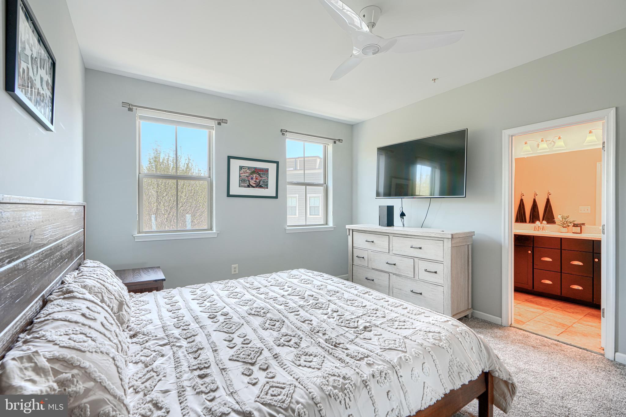 1309 Benjamin Street Baltimore, MD 21230 - Photo 46 of 60 a bedroom with a large bed and a flat tv screen on dresser