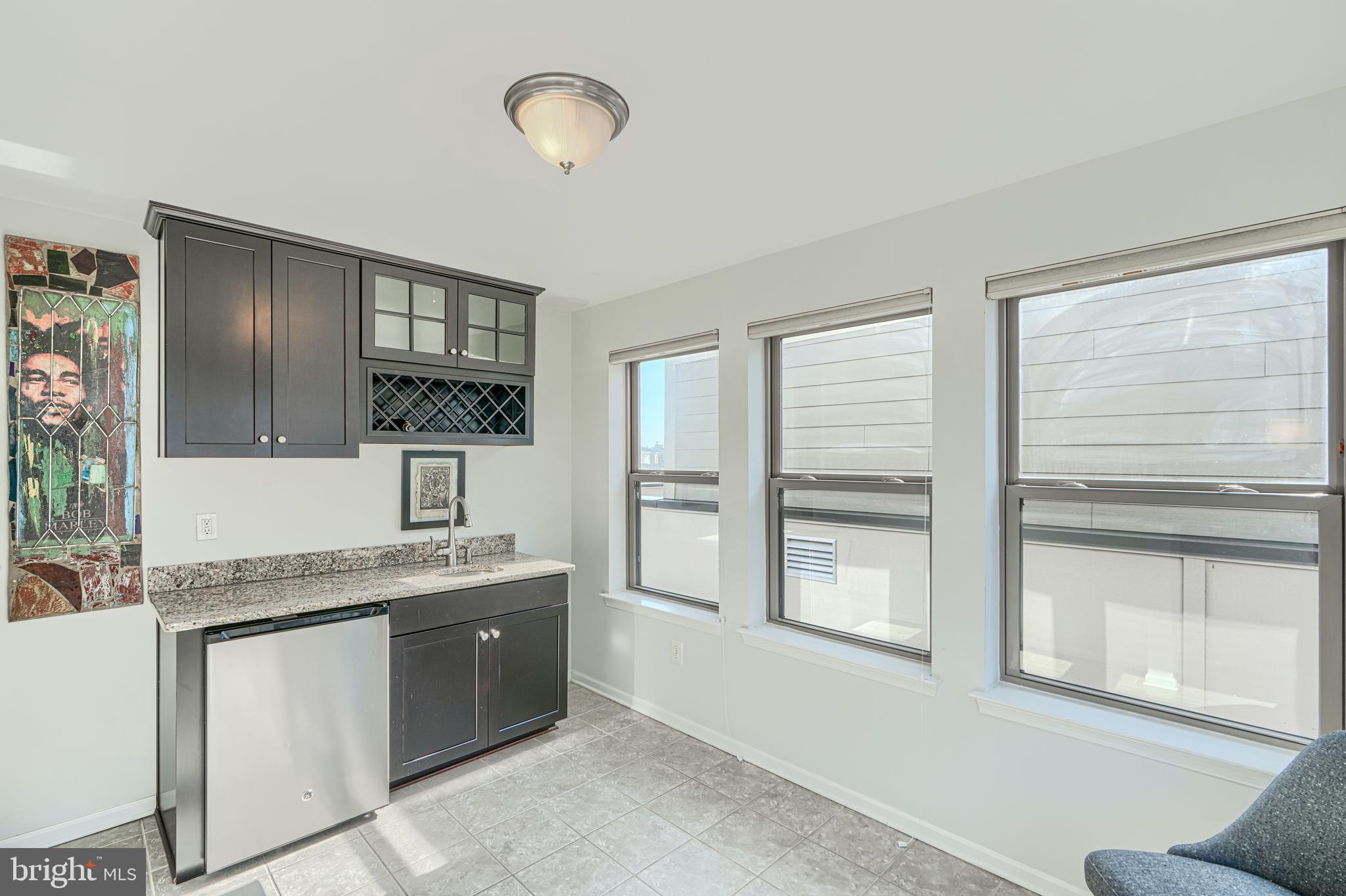 1309 Benjamin Street Baltimore, MD 21230 - Photo 50 of 60 a spacious bathroom with a granite countertop sink and a window