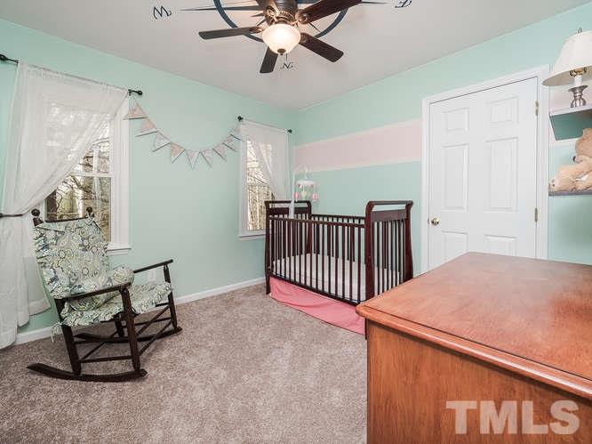 2312 Anihinga Court Raleigh, NC 27616 - Photo 11 of 25 a bedroom with a bed and a chandelier