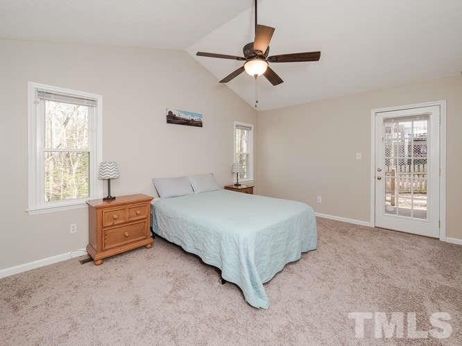 2312 Anihinga Court Raleigh, NC 27616 - Photo 12 of 25 a spacious bedroom with a bed and a chandelier