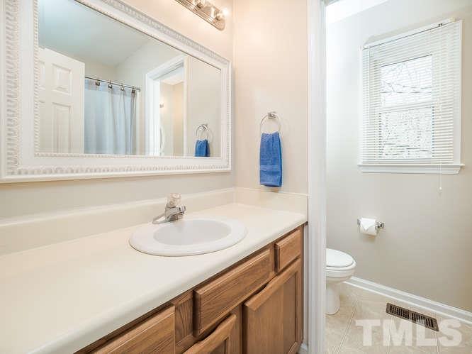 2312 Anihinga Court Raleigh, NC 27616 - Photo 15 of 25 a bathroom with a sink a toilet and a mirror