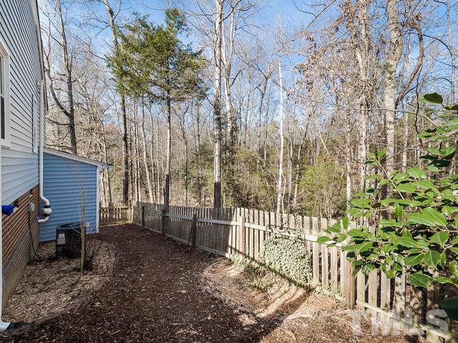 2312 Anihinga Court Raleigh, NC 27616 - Photo 20 of 25 a view of a house with a small yard and wooden fence
