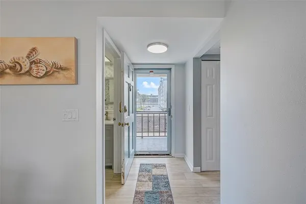 a view of a hallway with wooden floor