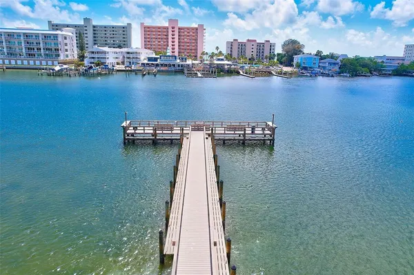 a view of a swimming pool with lawn chairs