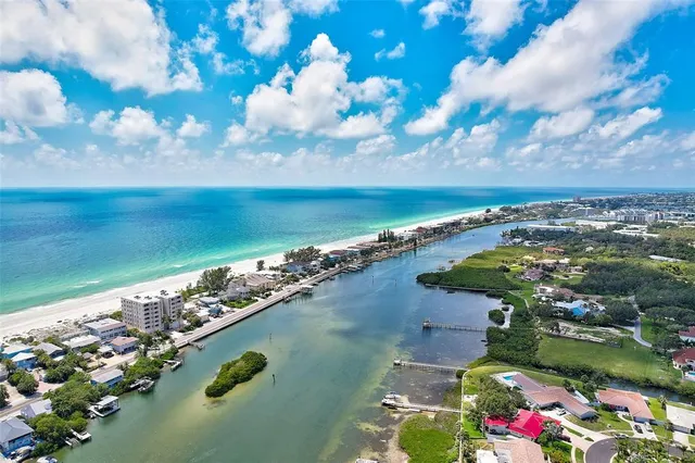 an aerial view of residential houses with outdoor space and lake view