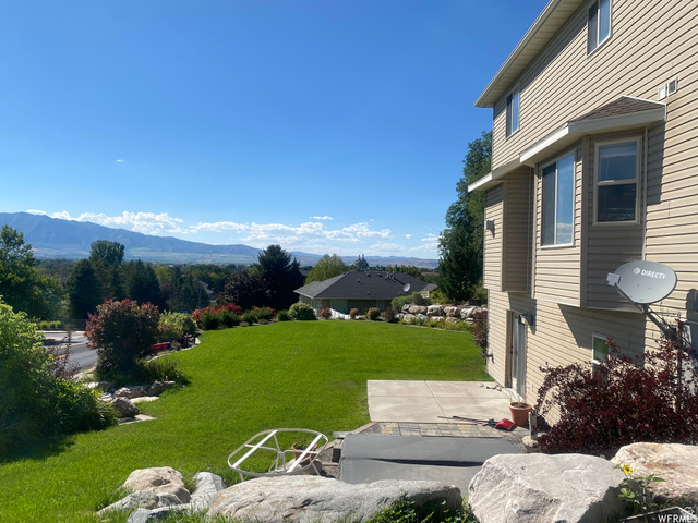 83 Canterbury Circle Logan, UT 84321 - Photo 22 of 23 View of green lawn featuring a mountain view