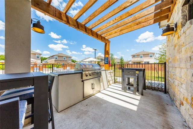 a open kitchen with a sink and chandelier