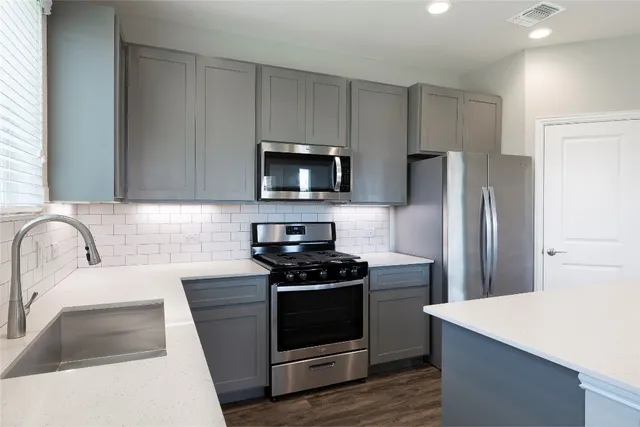 a kitchen with a refrigerator stove and microwave