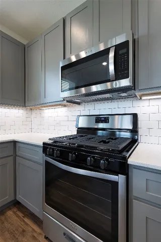a stove top oven sitting inside of a kitchen