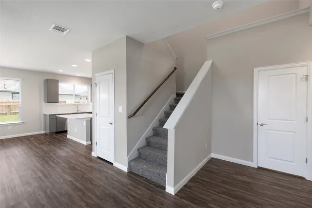 a view of a kitchen with wooden floor and electronic appliances