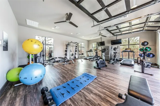a room with wooden floors and lots of mirrors