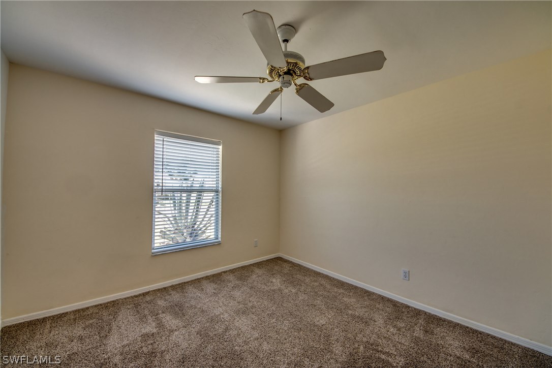 17517 Braddock Road Fort Myers, FL 33967 - Photo 24 of 33 an empty room with windows and fan