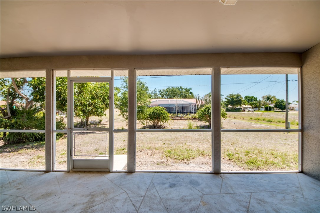 17517 Braddock Road Fort Myers, FL 33967 - Photo 29 of 33 a view of an empty room with wooden floor and a large window with pool view
