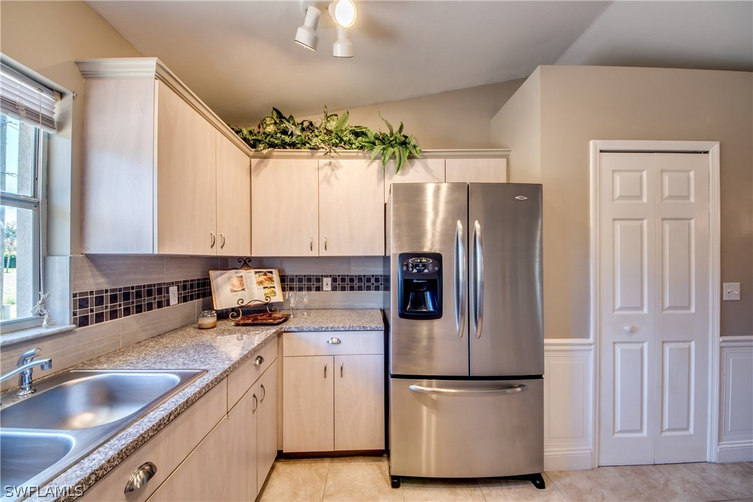 17517 Braddock Road Fort Myers, FL 33967 - Photo 4 of 33 a kitchen with a refrigerator sink and cabinets