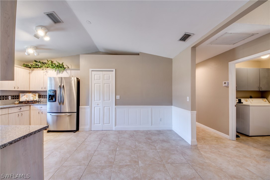 17517 Braddock Road Fort Myers, FL 33967 - Photo 7 of 33 a view of a kitchen with a refrigerator and a stove