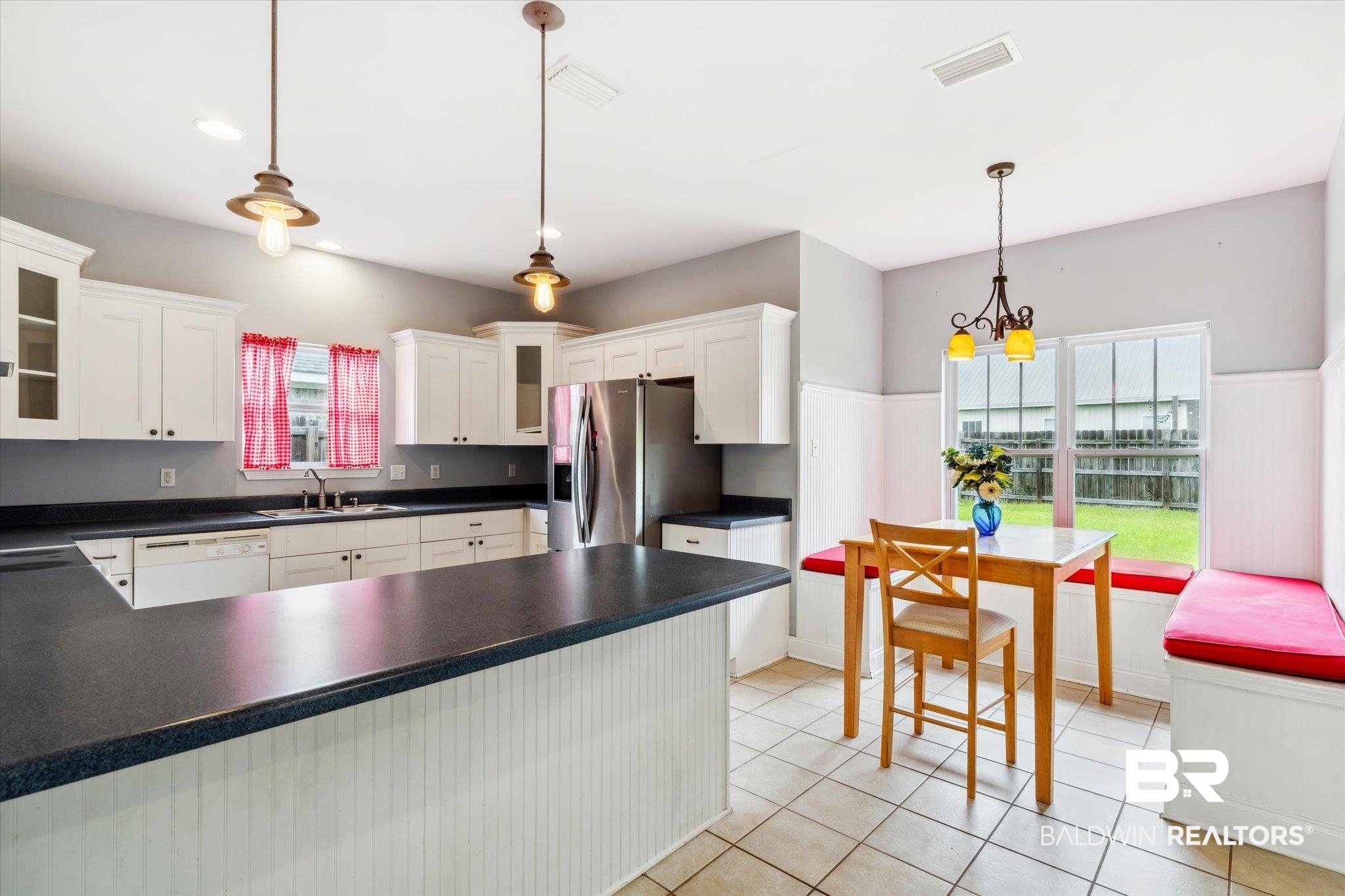 17297 Tallasee Boulevard Foley, AL 36535 - Photo 7 of 24 Kitchen featuring white cabinets, pendant lighting, sink, stainless steel fridge, and light tile patterned floors