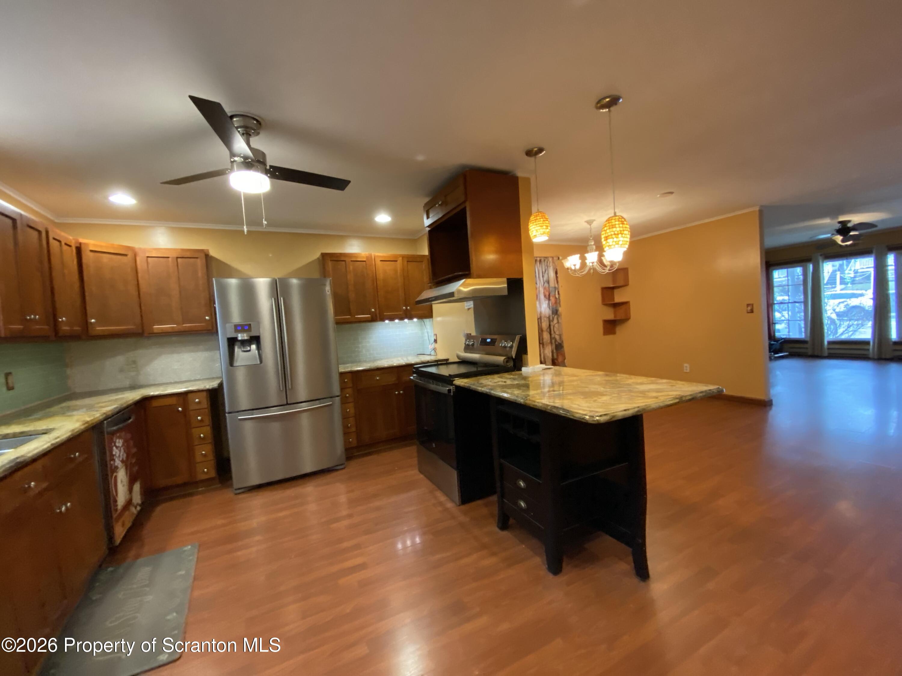 1019 Moosic Street Scranton, PA 18505 - Photo 15 of 43 a kitchen with stainless steel appliances granite countertop a sink a stove and a refrigerator