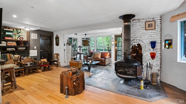 a roof deck with table and chairs and potted plants