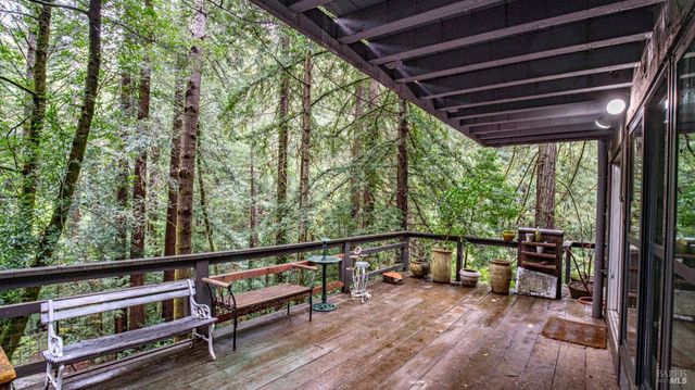 a living room filled with furniture and large windows
