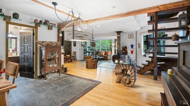 a living room with furniture and a floor to ceiling window
